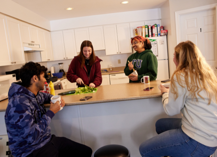 Students preparing a meal together students in kitchen preparing a meal
